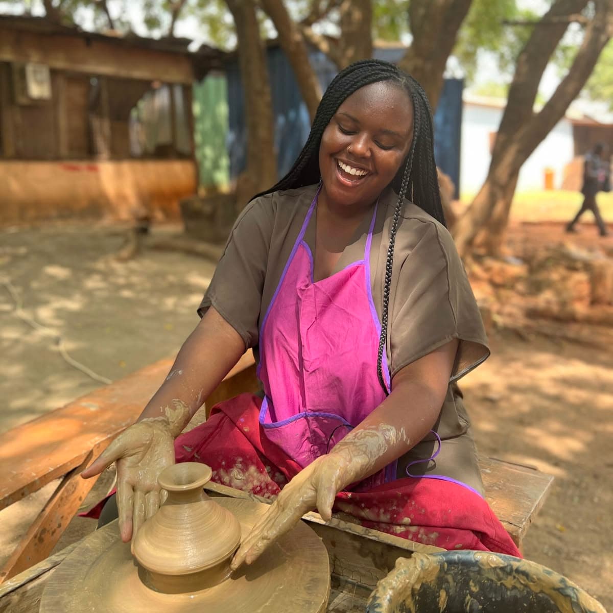 Woman at pottery wheel creating a ceramic piece